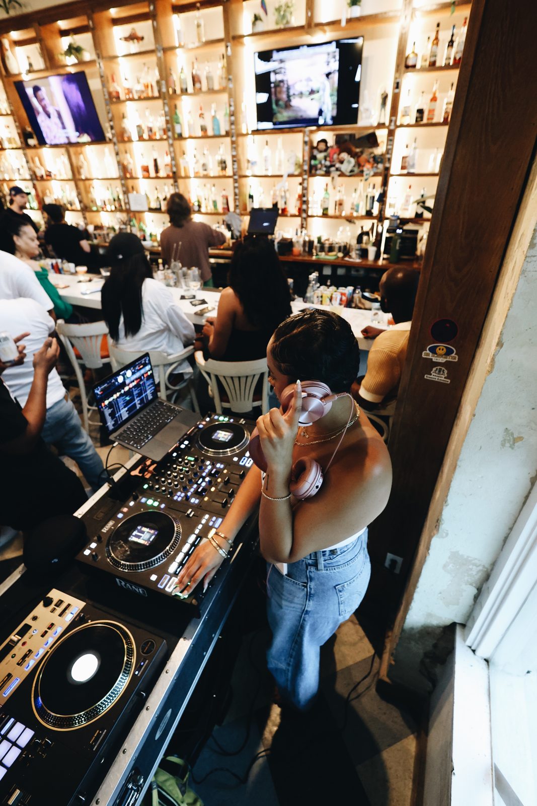 Bri Marie playing a bar set with her pink headphones on